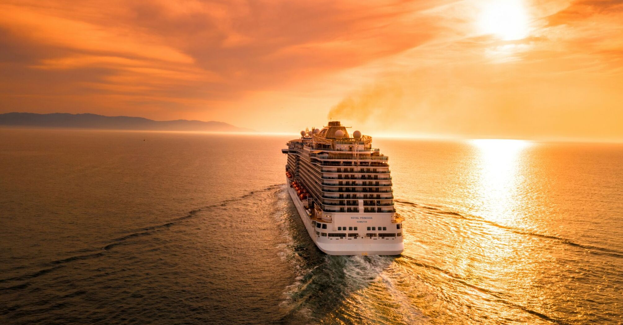 White cruise ship during sunset