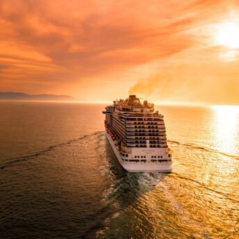 White cruise ship during sunset