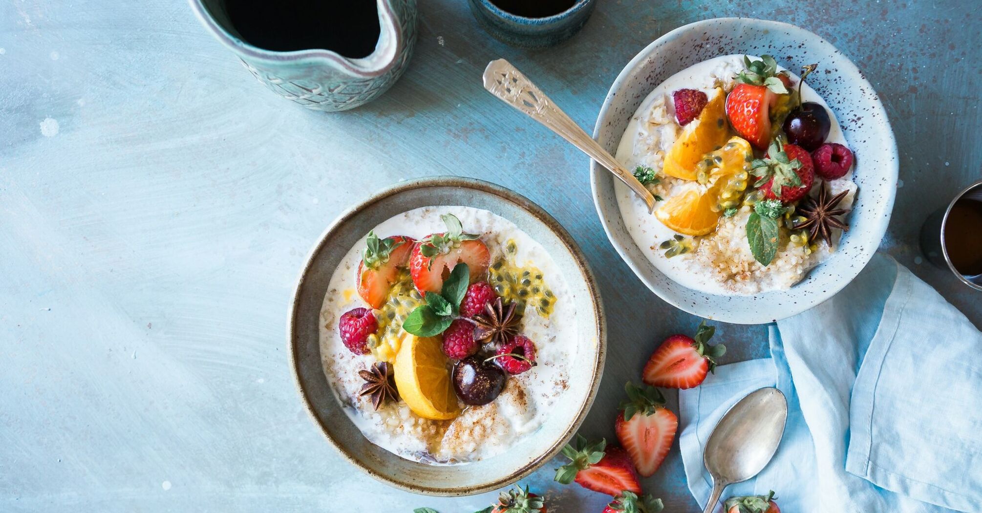 A vibrant breakfast spread featuring overnight oats topped with fresh strawberries