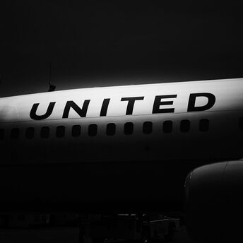 White and black United Airlines airplane during night time