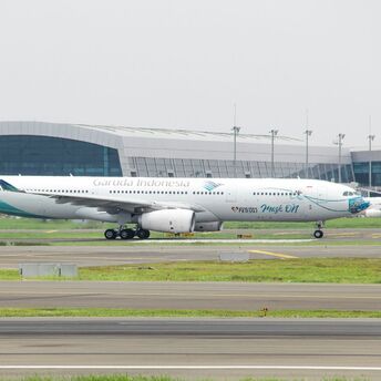 A large Garuda Indonesia passenger jet sitting on top of an airport runway