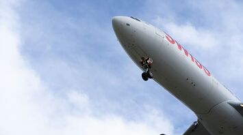 Close-up of a SWISS plane in flight from below
