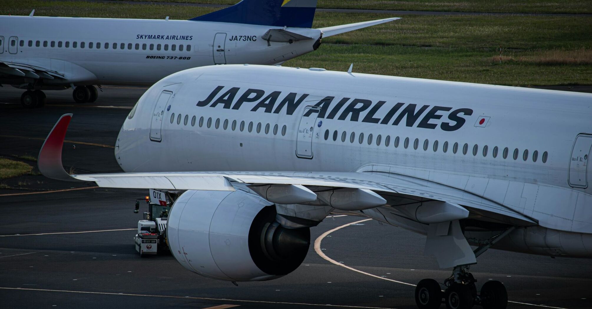 Japan Airlines aircraft being serviced on the tarmac