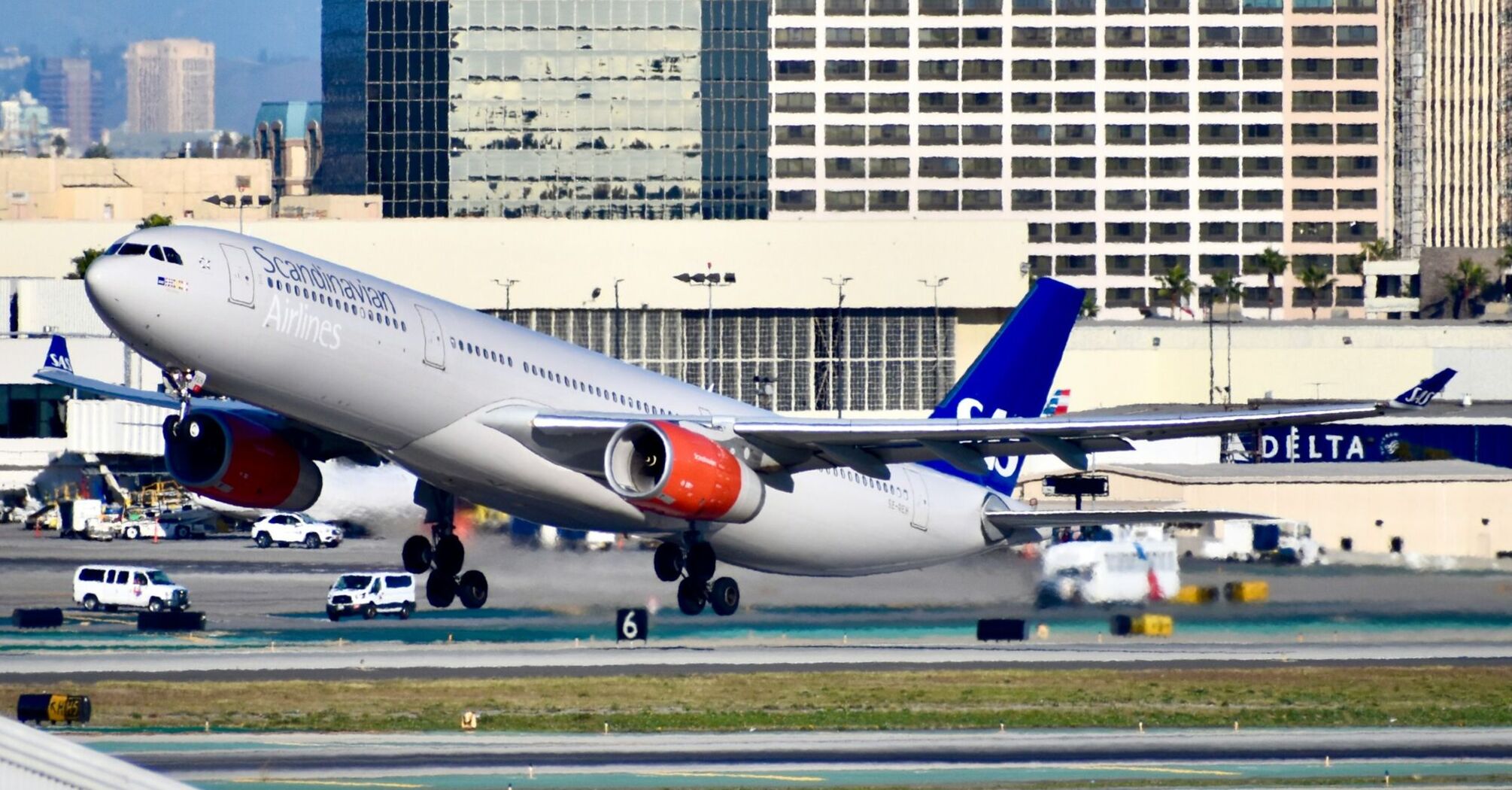 SAS airplane taking off from a city airport