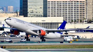 SAS airplane taking off from a city airport