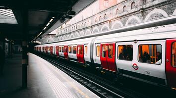 A white and red train on a station