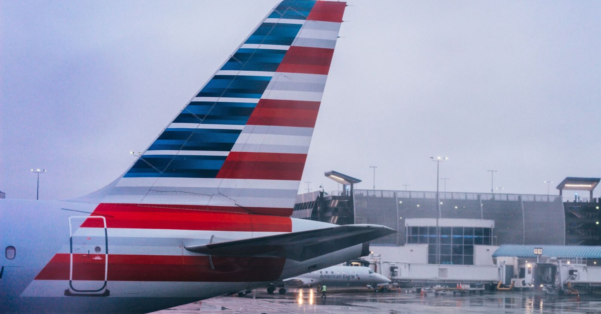 A large jetliner sitting on top of an USA airport tarmac