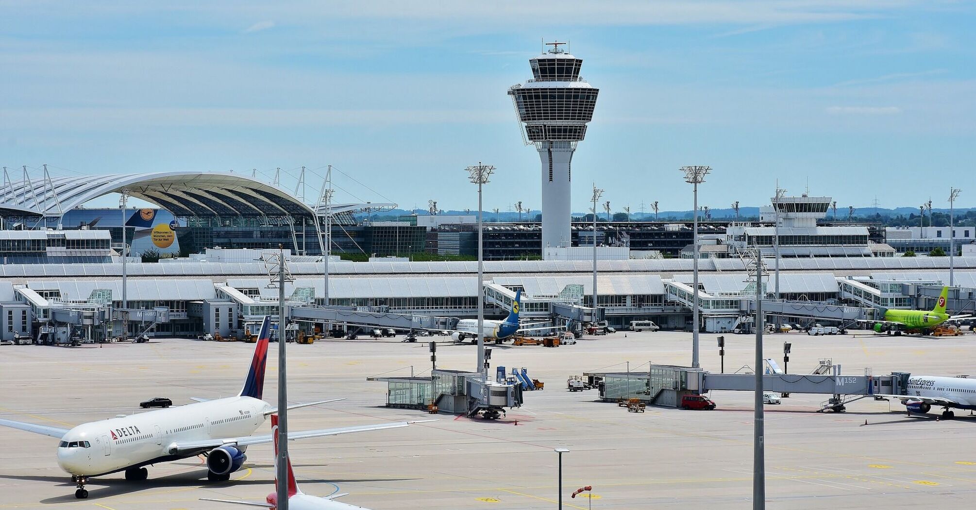 Munich Airport with planes on the tarmac and control tower in the background