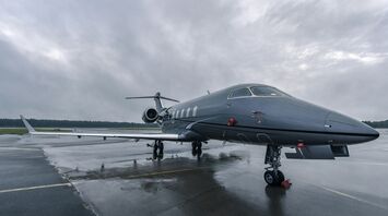 A Bombardier jet sitting on top of an airport tarmac