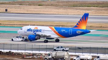 Blue and white passenger plane in Los Angeles International airport