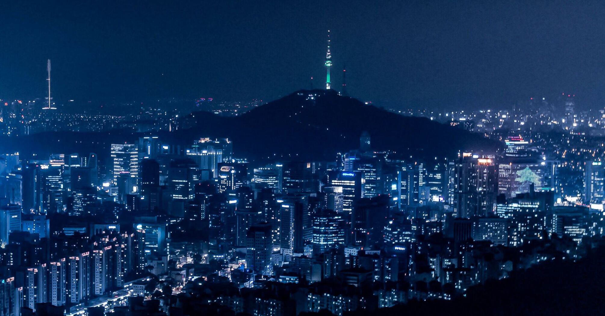 Seoul cityscape at night with illuminated buildings and Namsan Tower