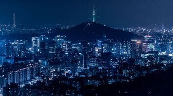Seoul cityscape at night with illuminated buildings and Namsan Tower