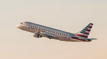 Eagle Embraer passenger jet flying through a cloudy sky