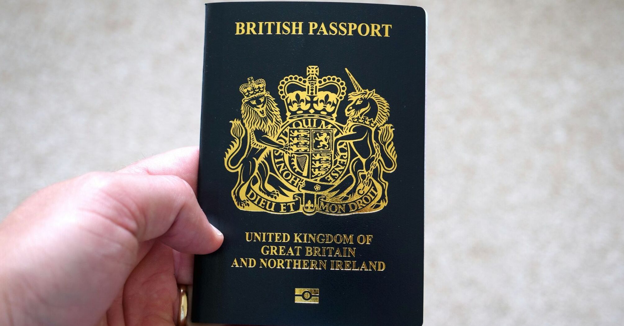 Hand holding a British passport
