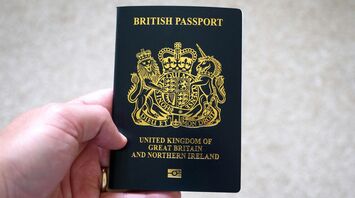 Hand holding a British passport