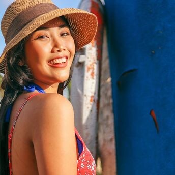 Woman wearing sun hat and floral top