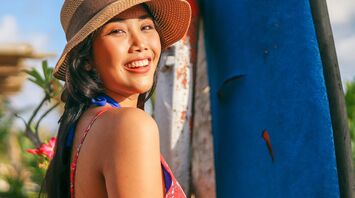 Woman wearing sun hat and floral top