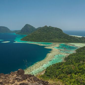 Green sea surrounded with mountains