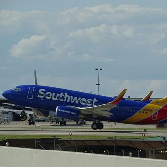 A Southwest Airlines plane landing on the runway during the day