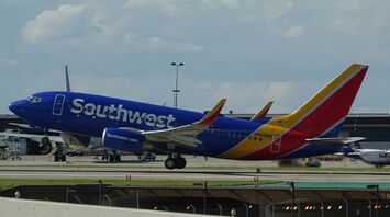 A Southwest Airlines plane landing on the runway during the day
