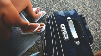 Woman with suitcase waiting to board a flight