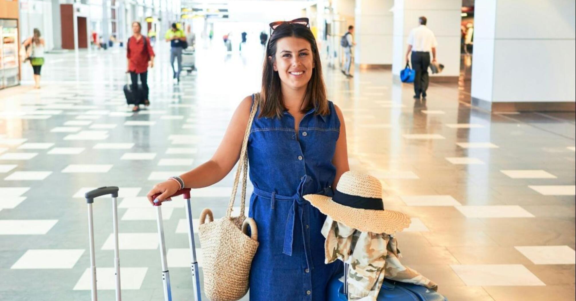 A woman with three suitcases at the airport