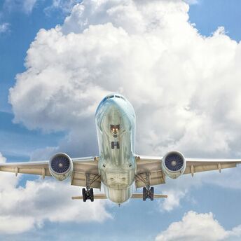 Gray and white airplane on flight near clear blue sky