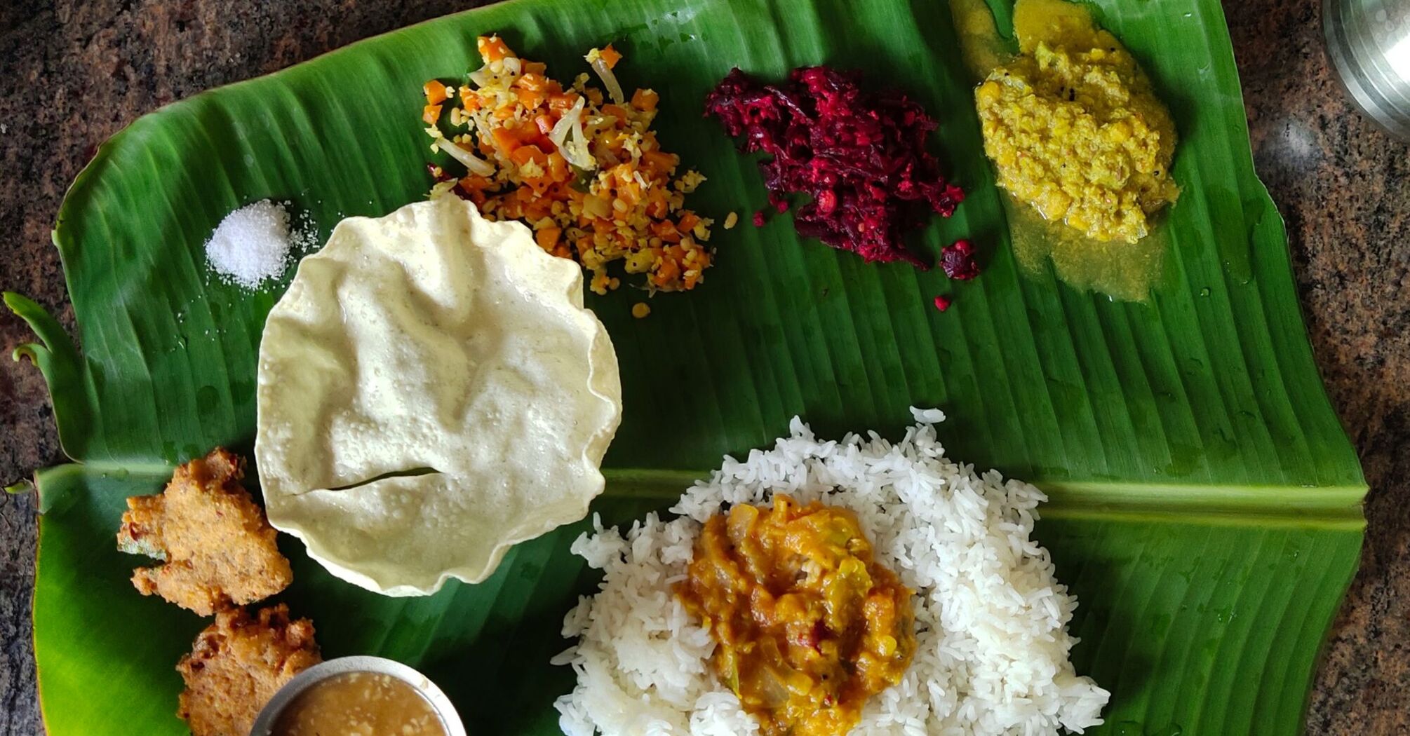 Indian food on green leaf