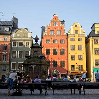 People sitting on the benches in front of building in Stockholm