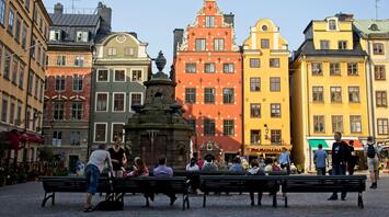 People sitting on the benches in front of building in Stockholm