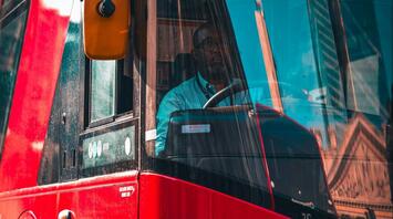 A driver sitting in the bus