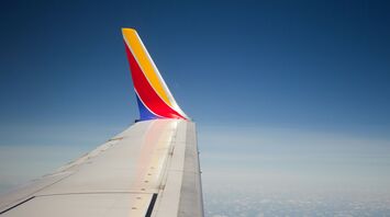 Southwest Airlines wing in flight over clouds