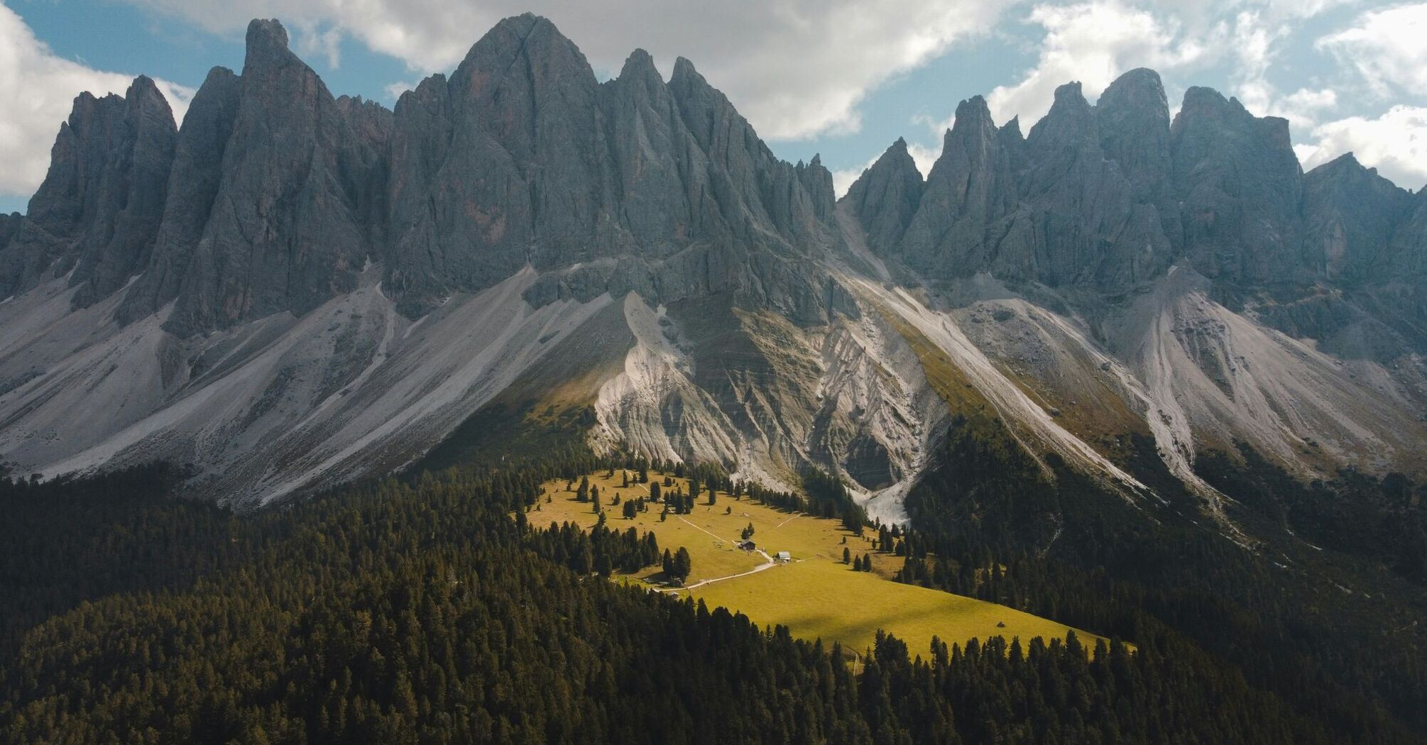 An aerial view of a Dolomites mountains range with trees