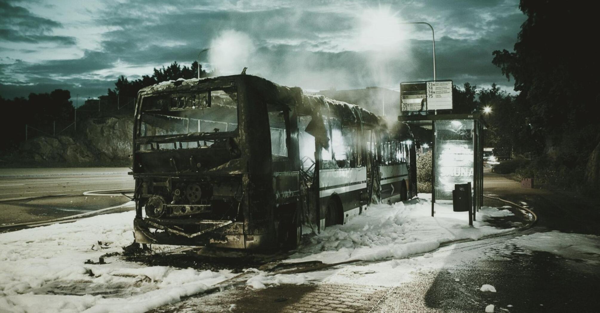 A burnt bus at the bus stop