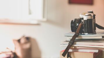 Vintage camera on top of stacked books