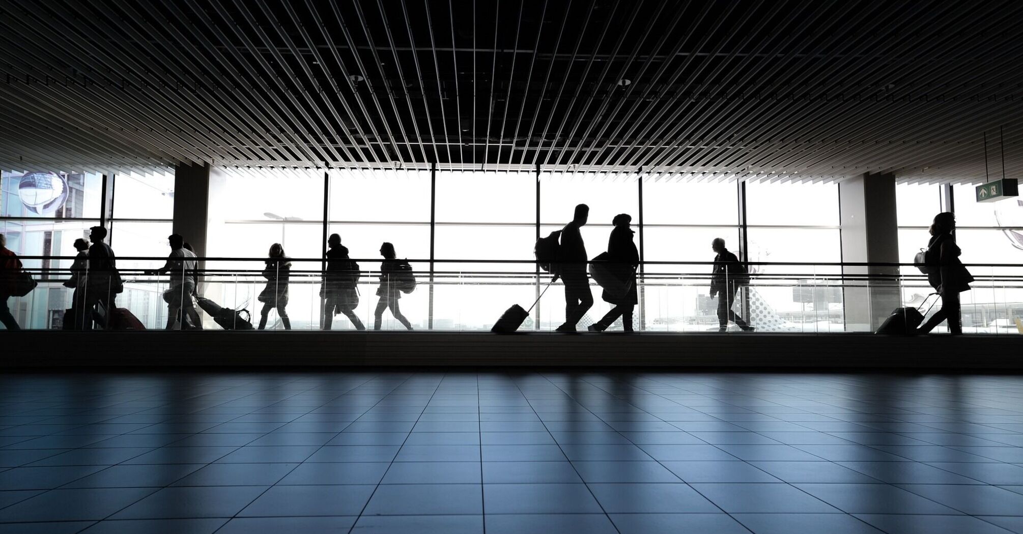 Travelers walking through an airport terminal
