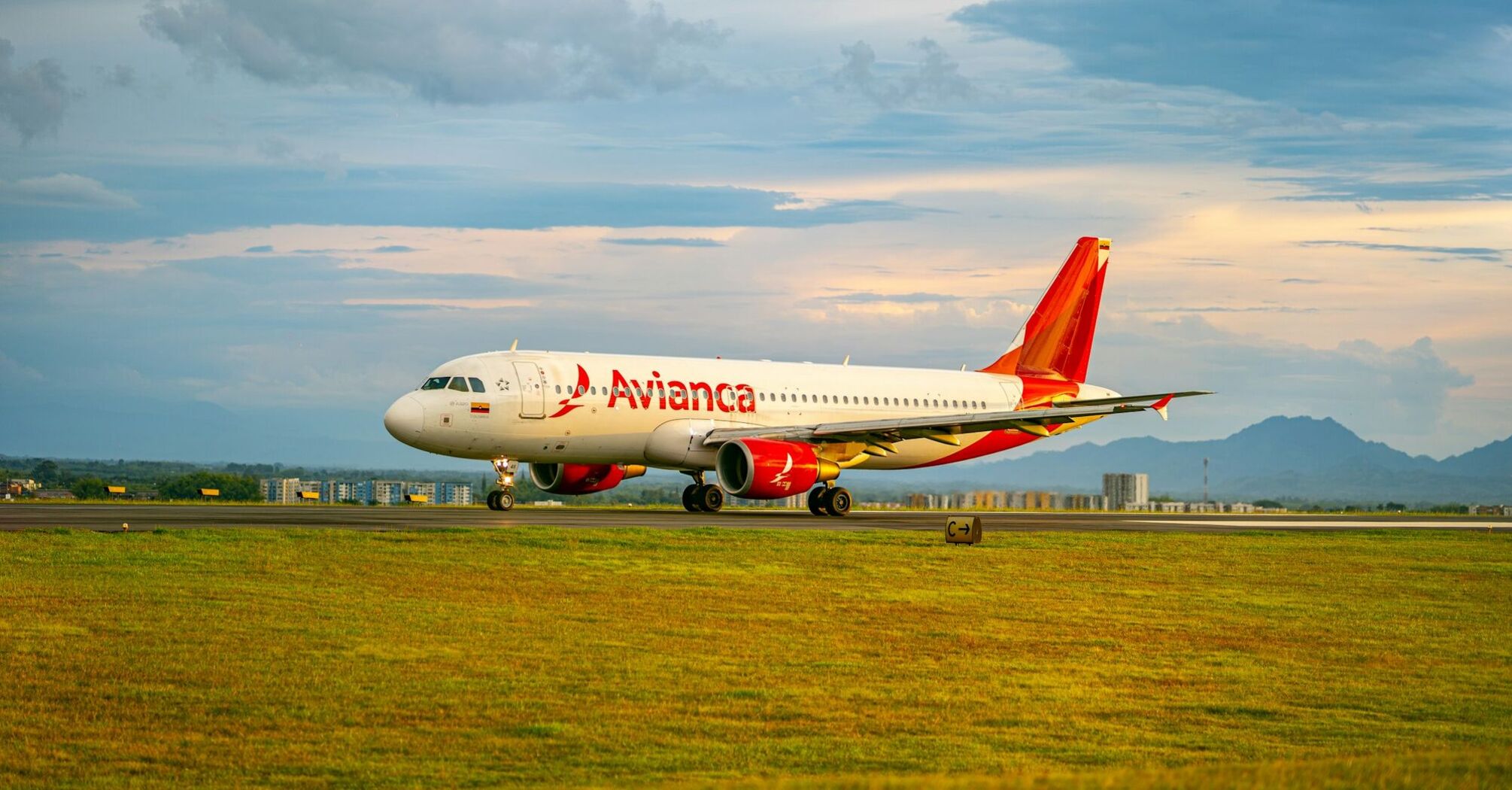 Avianca airplane on the runway at sunset