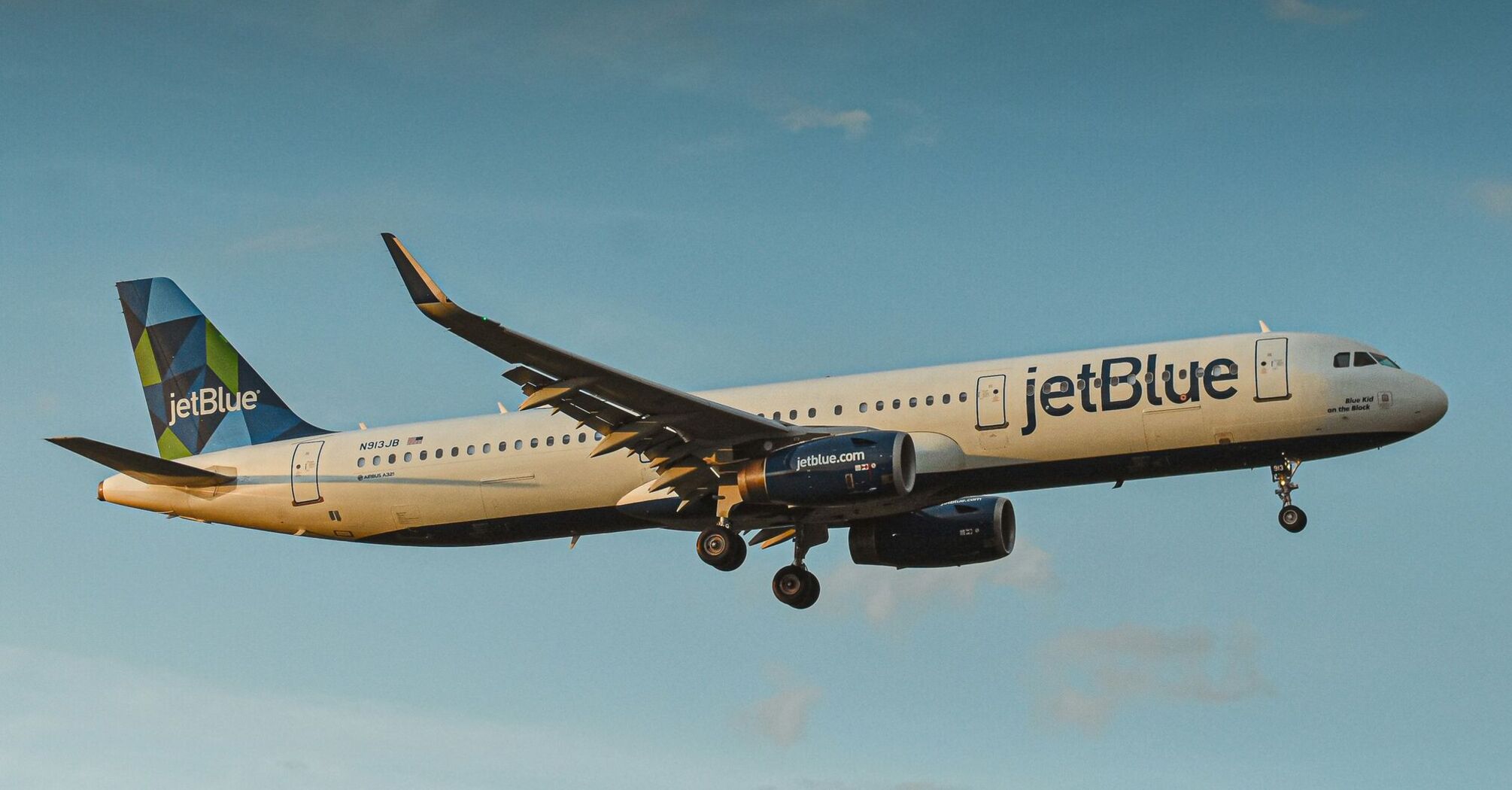 A large JetBlue airplane flying in the sky