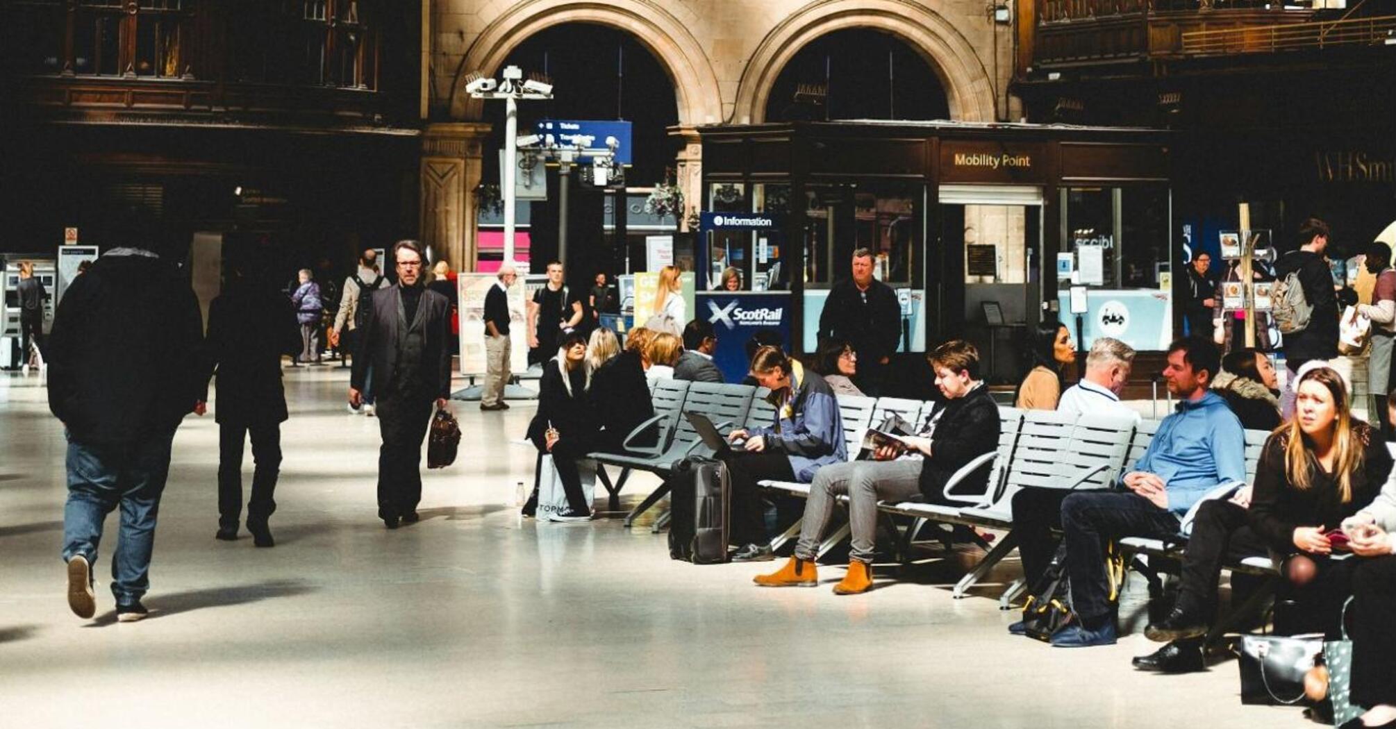 Interior of Glasgow Central Station with passengers waiting and walking