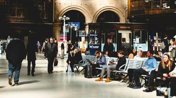 Interior of Glasgow Central Station with passengers waiting and walking