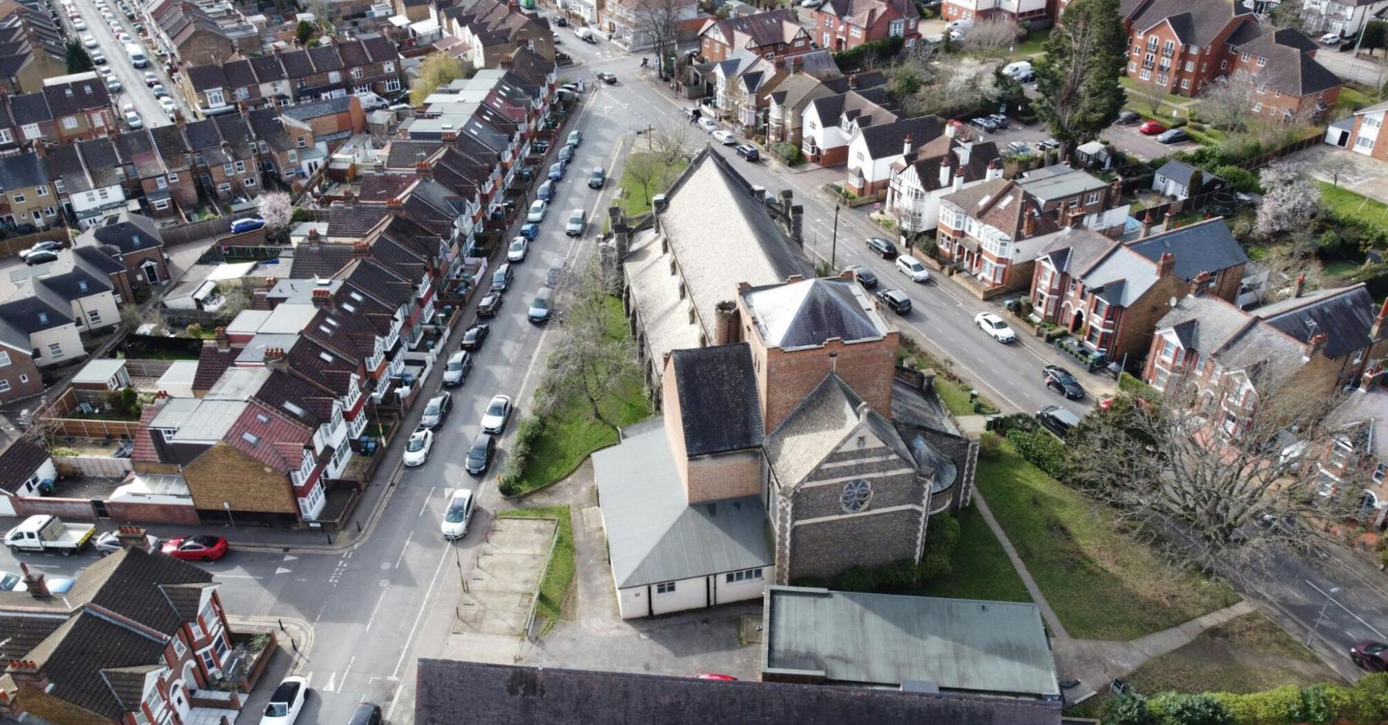 Aerial view of a residential neighborhood in Watford with a mix of houses and a church