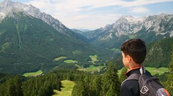 The kid is watching the mountains