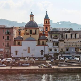 A view of a church and surrounding buildings in Pozzuoli, Italy