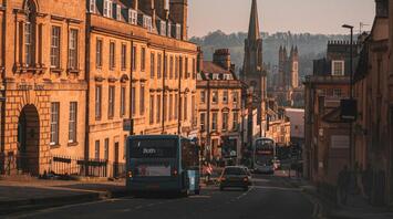 Historic street in Somerset with buses and cars under a clear sky