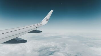 Lufthansa airplane wing above the clouds