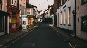 A quiet street in a historic town with old buildings lining both sides