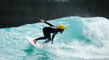 Man riding the surfboard in the pool