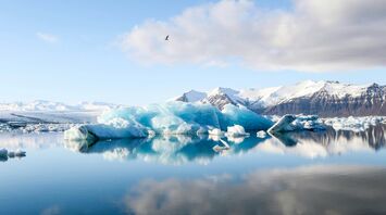 icebergs and alp mountains facing calm body of water