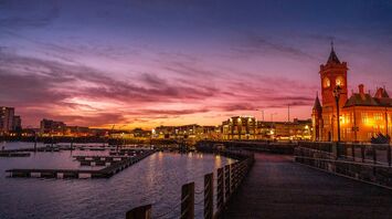 Cardiff skyline at sunset with waterfront and historic building