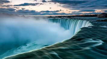 Niagara Falls at dawn with mist rising